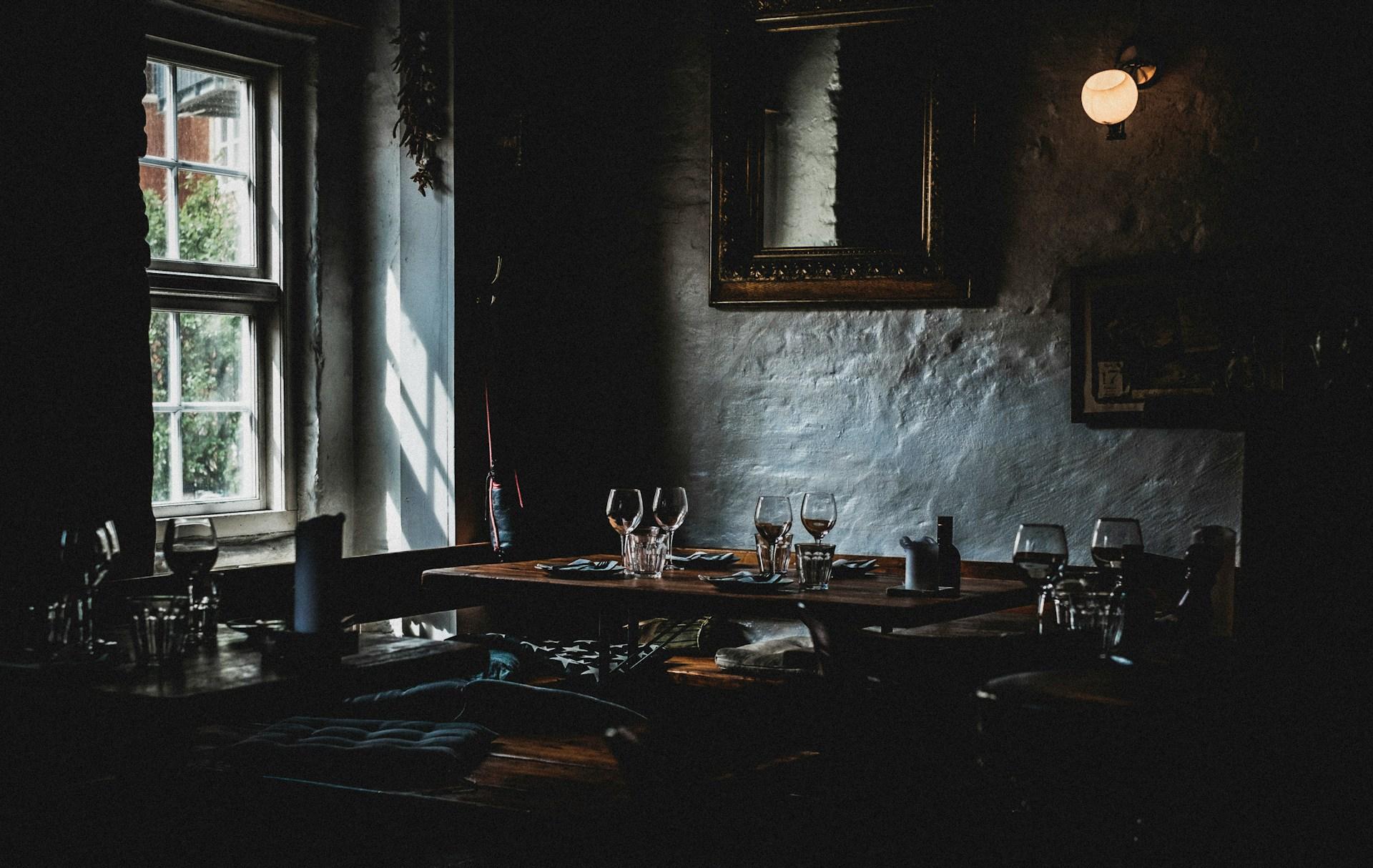 A warmly lit tavern interior — the kind of atmosphere a fantasy murder mystery night aims for